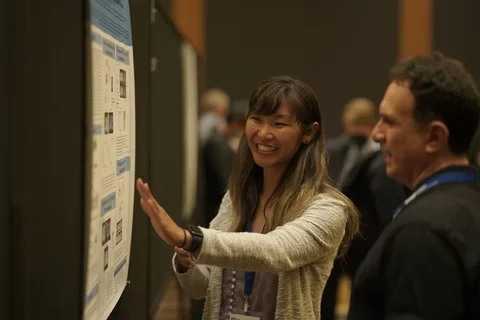 Participant presenting at poster competition 