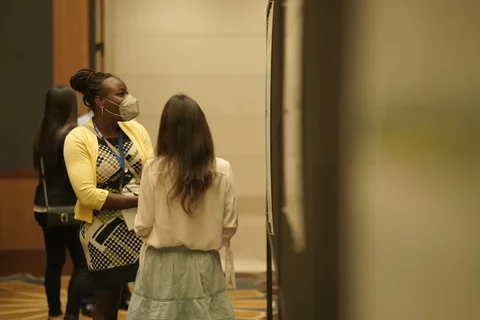 Trainees having a conversation at the JCCC retreat poster competition.