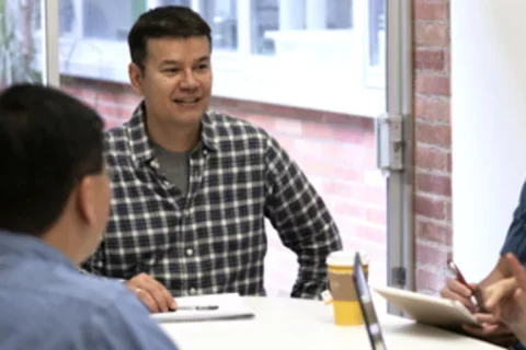 A group of staff from the Financial Affairs office around a conference table in discussion