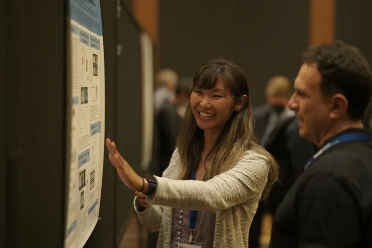 Participant presenting at poster competition 