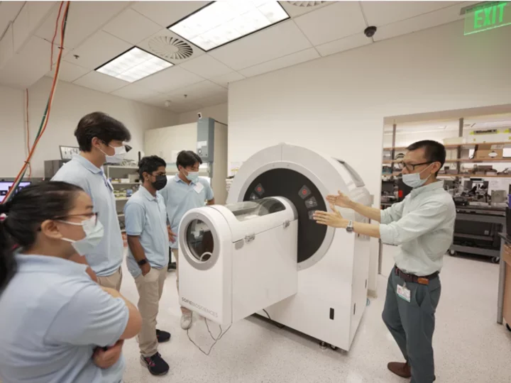 Shared Resource Small animal imaging team giving a lab tour to highschool students