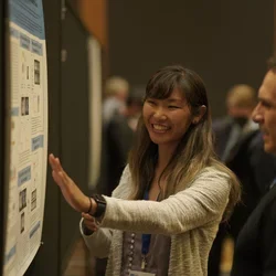 Participant presenting at poster competition 