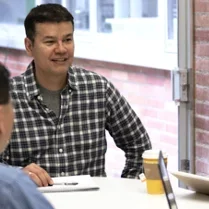 A group of staff from the Financial Affairs office around a conference table in discussion